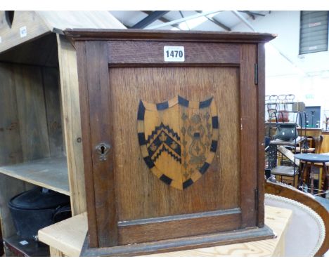 A VINTAGE OAK SMOKERS CABINET WITH INLAID ARMORIAL CREST 