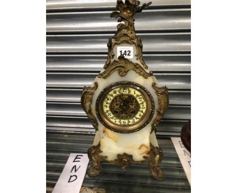 AN ORMOLU MOUNTED AGATE BALLOON SHAPED CLOCK STRIKING ON A COILED ROD