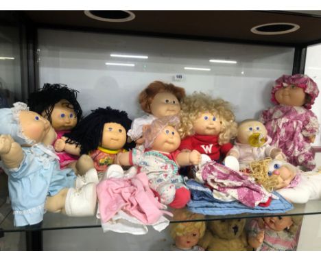 A COLLECTION OF NINE VINTAGE CABBAGE PATCH KIDS DOLLS WITH SOME EXTRA CLOTHING.