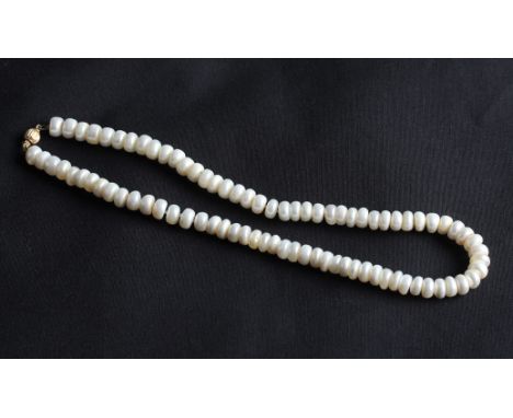 A choker length string of button pearls, fitted with a yellow metal sphere clasp, length approx. 15".