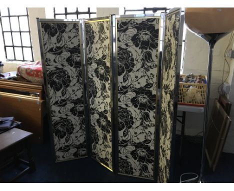 A chrome framed four panel dressing screen.