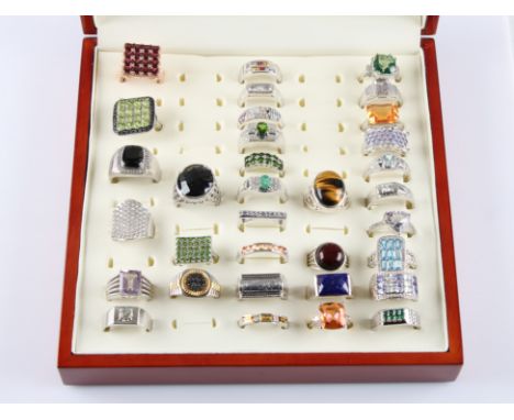 A lot of thirty-three gemstone set rings, to include, fire opal, amethyst, tourmaline, topaz, meteorite, sapphire, rainbow sa