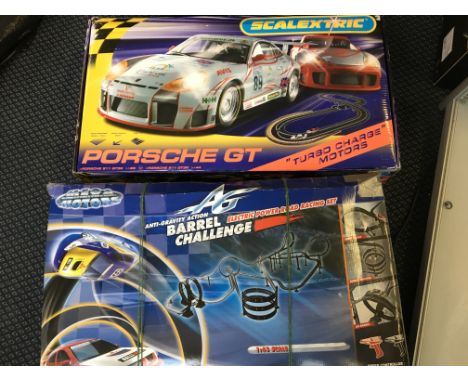 A Scalextric Porche GT set, with a Mega Motors anti-gravity action barrel challenge electric power road racing set.