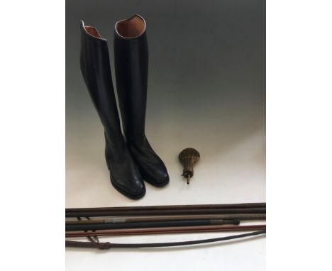 A pair of riding boots, riding crop, brass powder flask and shotgun ram rods.