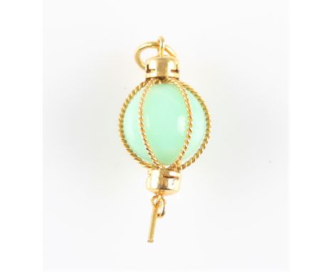 A green jade sphere pendant, set with a jade sphere encased in rope twist design, unmarked yellow metal, length approx. 3.5cm
