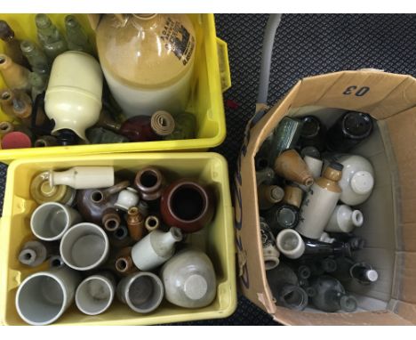 Three boxes containing various glass and ceramic bottles, vases and jugs.