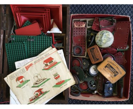 A selection of Meccano parts, with a Bayko building set.
