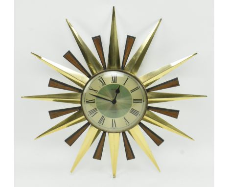 Metamec - a retro mid 20th century sunburst hanging wall clock. The clock having a silver face with ebonised chapter ring wit