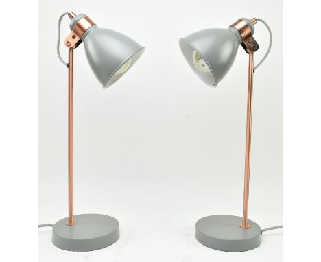 A pair of contemporary designer table / desk lamp lights. Each lamp having adjustable grey pendant shades supported by copper