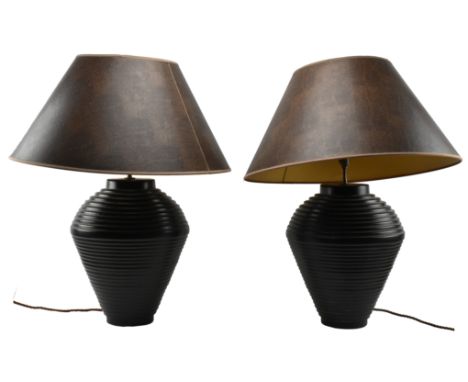 A large pair of contemporary designer ceramic table lamp lights. Each lamp having large faux leather conical shades over ribb