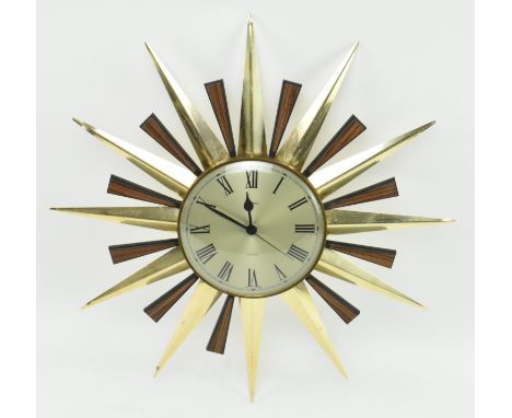 Metamec - a retro mid 20th century sunburst hanging wall clock. The clock having a silver face with ebonised chapter ring wit