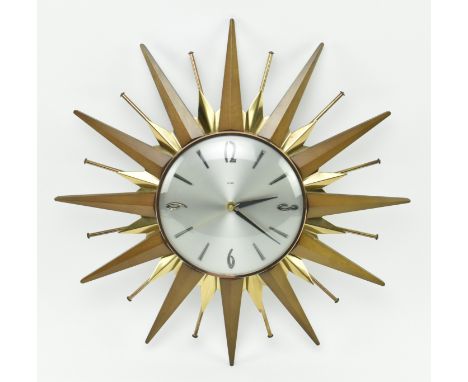 Metamec - a mid century 1960s sunburst style retro hanging wall clock. The clock with silver face and chapter ring, teak &amp