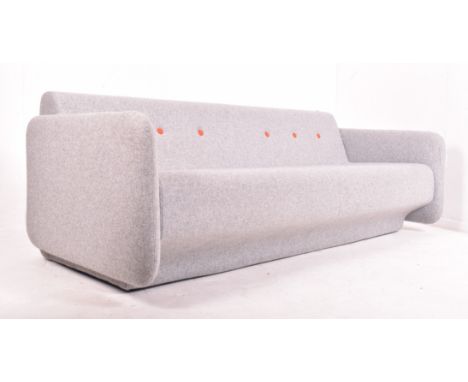 Orangebox - A contemporary upholstered three seater sofa settee. The sofa upholstered in grey fabric with orange buttons to b