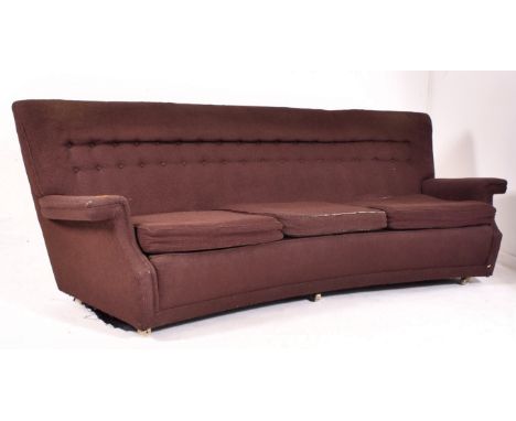 A retro mid 20th century curved button backed three seater sofa settee. The sofa of curved form having button backed upholste