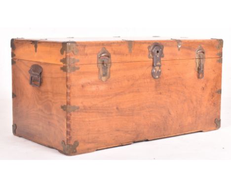 A vintage early 20th century fruitwood &amp; brass bound travel trunk chest. The trunk having a chamfered edge rectangular to