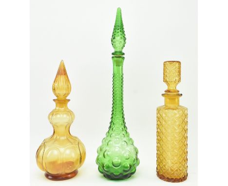 A collection of three vintage 20th century &amp; later coloured moulded glass genie decanters bottles with stoppers. The lot 