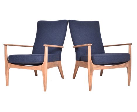 Parker Knoll - Model PK 873/4 - a pair of mid 20th century armchairs / lounge chairs. Each chair raised on tapered legs, with