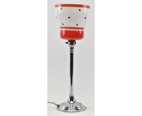 A retro mid century 1950s style modernist table lamp. The desk lamp featuring milk glass shade with red enamel striped border