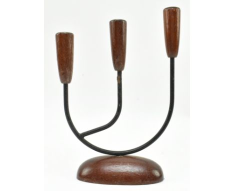 A retro 20th century Danish design candlestick holder. The candlestick having three turned teak holder tops supported by meta