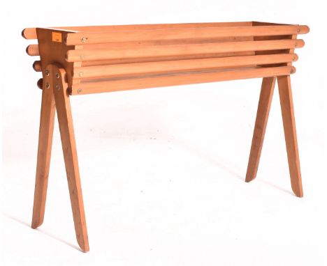 A vintage mid 20th century teak planter / plant stand. The planter having a rectangular slatted top over tapering splayed leg