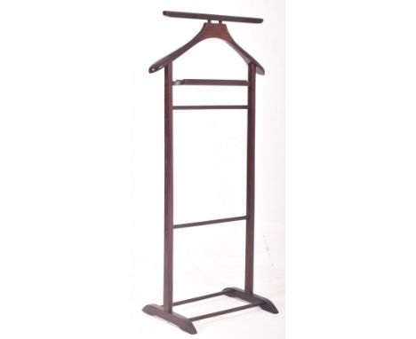 A vintage 20th century stained teak gentleman's valet stand. The stand having a concave tray atop raised on side supports uni