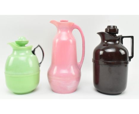 A collection of three vintage mid century graduating Bakelite and Roanoid plastic water pouring jugs &amp; Thermos flasks. Th