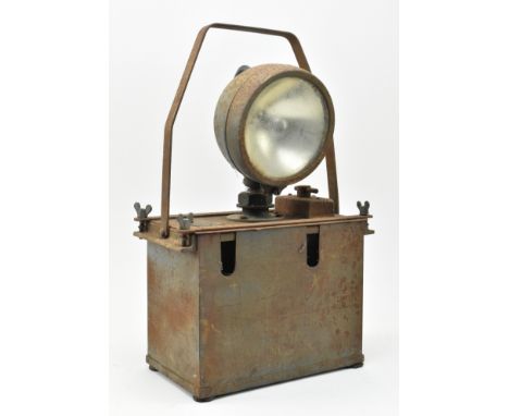 A vintage military WWII rusted iron signal lamp, suited for decorative use. The lamp with folding handle, central bulb over b