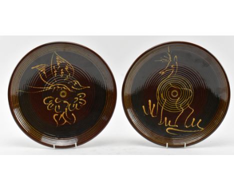 Two vintage Puidgemont studio art pottery ceramic charger plates. Each charger plate decorated with yellow/maroon/olive/brown