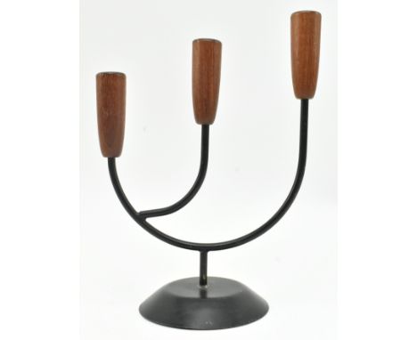 A retro 20th century Danish design candlestick holder. The candlestick having three turned teak holder tops supported by meta