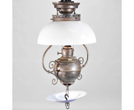 A brass hanging oil lamp, with an opaque glass shade, 60cm high