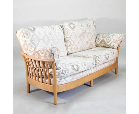 An Ercol light elm Renaissance sofa, with cream patterned cushions192w x 93d x 91hcm