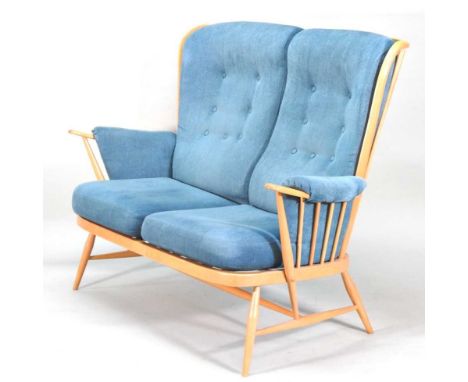 An Ercol Evergreen light elm sofa, with blue upholstered loose cushions, on splayed legs141w x 82d x 103h cm