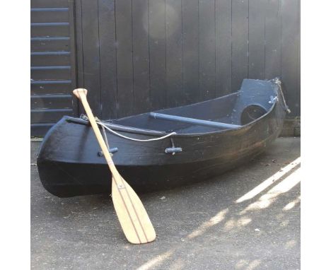 A Canadian style painted wooden canoe, 310cm long, with paddle