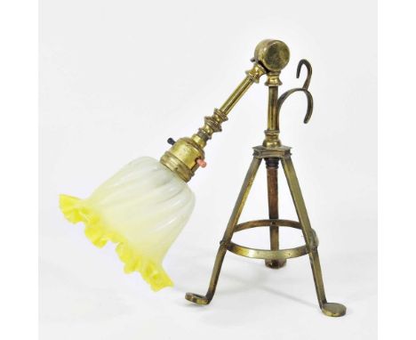 An Arts and Crafts brass adjustable table lamp, circa 1900, in the manner of W A S Benson, with a frilled yellow glass shade,