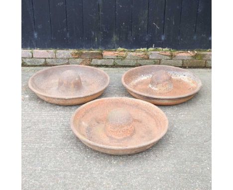 A cast iron pig trough, 66cm diameter, together with two others similar (3)