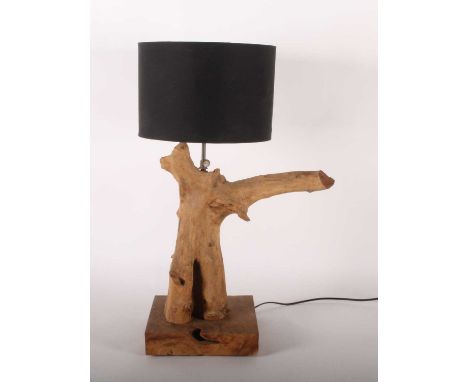 A table lamp, constructed from a tree branch, having a black shade, h.67cm including shade