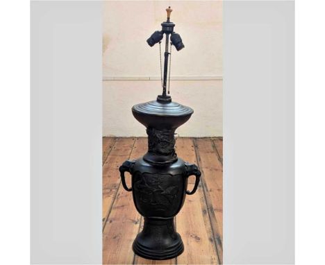 A large Japanese bronze table lamp base, Meiji period (1868-1912), flanked by zoomorphic handles and relief decorated with bi