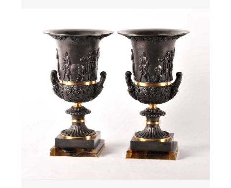 A pair of impressive Neo-Classical bronze and ormolu urns, 20th century, after the antique, each of campana form, relief deco