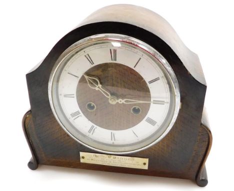 A 1950's oak cased mantel clock, with a circular dial, with a silver plaque inscribed presented to W Barker on retirement by 