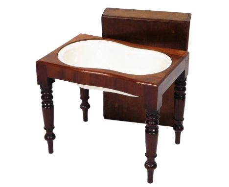 A Victorian mahogany bidet, the rectangular removable cover enclosing a shaped ceramic basin on turned tapering legs, the lar