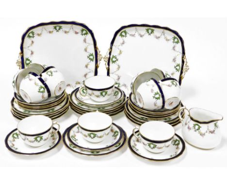 A Royal Crown Derby part tea and dinner service, comprising of two cake plates, milk jug, twelve tea cups and saucers and twe