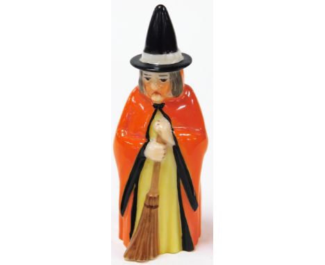A Royal Worcester witch candle snuffer, depicting a witch in red gown with broom, with purple Royal Worcester stamp to inside