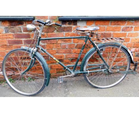 A Goldline Super Atlas gentlemans bicycle, on green metal frame, with bell and bicycle lamp, on a Brooks India seat. 