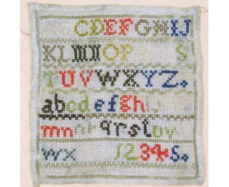 An early 20thC needlework sampler, depicting the alphabet and numbers one to five, 14cm x 14cm, in a modern wooden frame. 