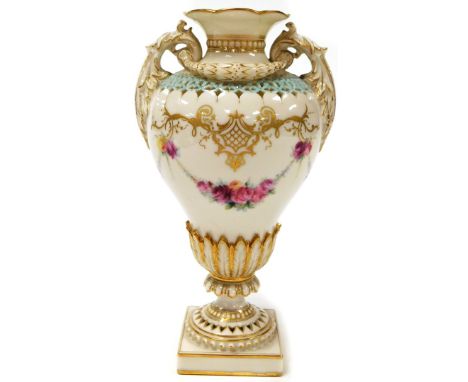 A Royal Worcester urnular vase, decorated in white, with pink and yellow roses, and a turquoise border with gilt decoration o