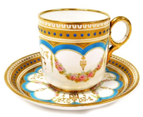 An early 20thC porcelain cup and saucer, decorated with gilt banding, blue enamel and pink roses, numbered in red to undersid