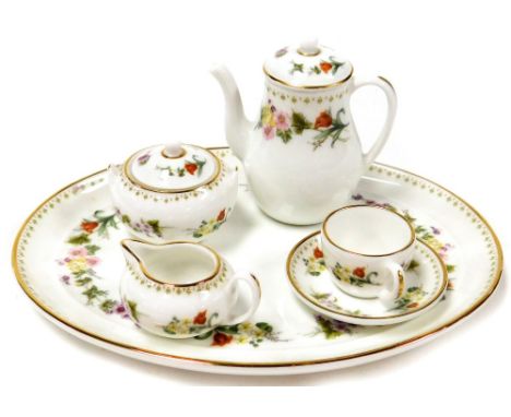 A Wedgwood miniature dolls tea service, comprising serving tray, tea pot, milk jug, sugar bowl and cup and saucer, in a flora