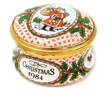 A Halcyon Days enamel Christmas trinket box, entitled Christmas 1984 depicting Santa Claus and holly decoration, 4.5cm diamet