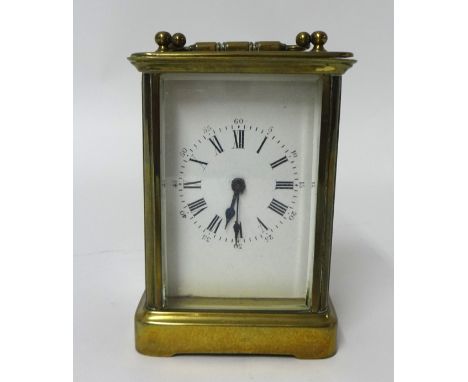 A French brass cased carriage clock with platform escapement and Roman and arabic numerals with key, 15cm handle up