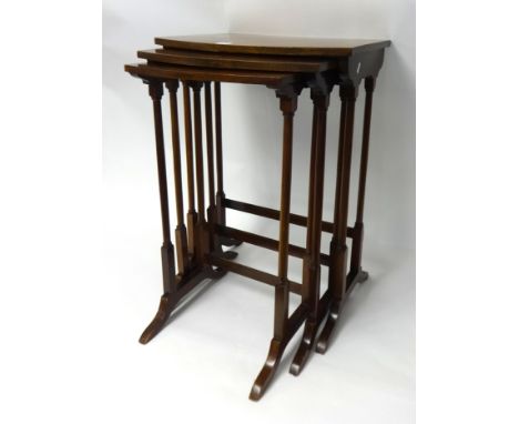 A mahogany nest of three tables, a reduced two door glazed cabinet and small Ercol elbow chair.